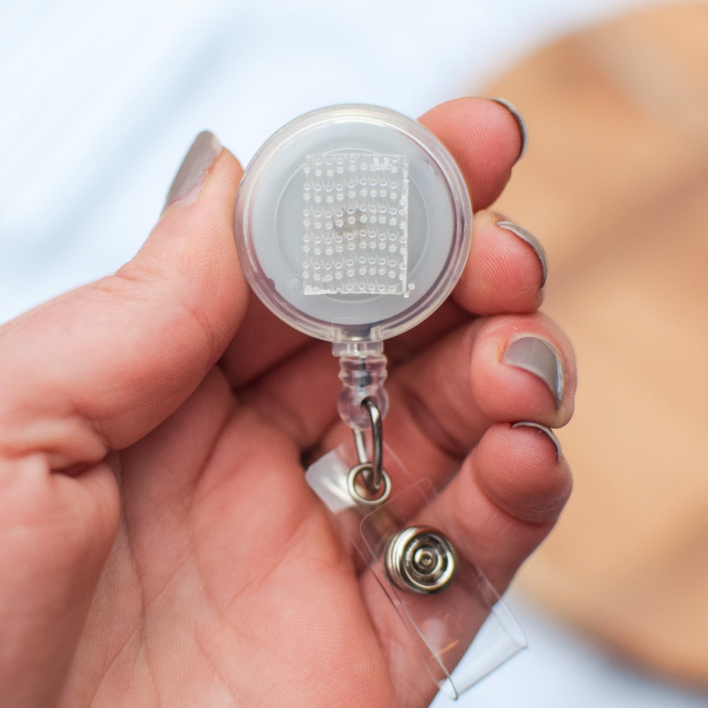 Interchangeable badge reel without topper, showing hook and loop fastener