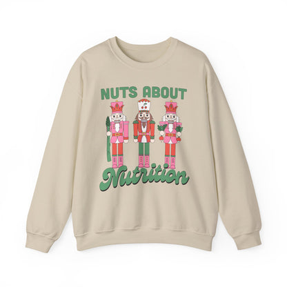 Sand colored sweatshirt with nutcracker design and text 'Nuts About Nutrition' on a white background