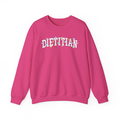 Deep pink sweatshirt with arched "DIETITIAN" text in white with multi-colored heart shaped Valentine candy sprinkled throughout the letters.
