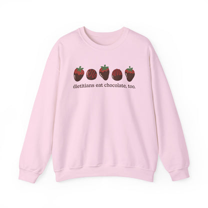 Pink sweatshirt with chocolate covered strawberries and truffles with the text "dietitians eat chocolate, too."