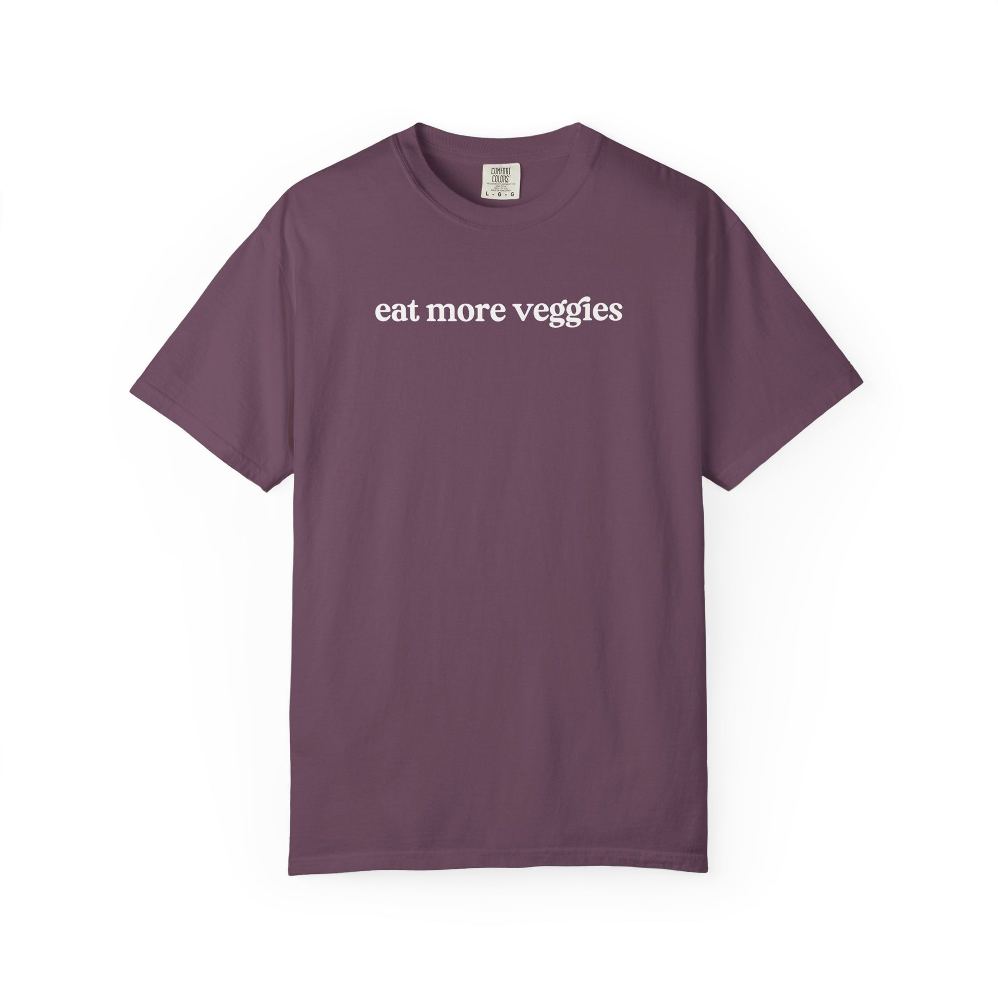 Purple t-shirt with 'eat more veggies' text on a white background