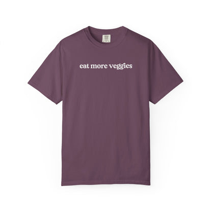 Purple t-shirt with 'eat more veggies' text on a white background