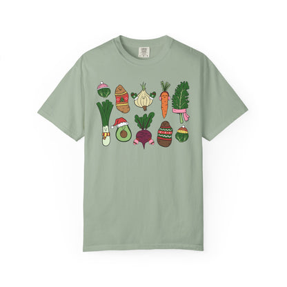 Green t-shirt with cartoon vegetable designs on a white background
