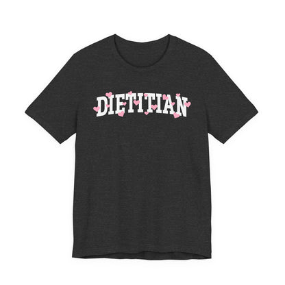 Charcoal tshirt with arched "DIETITIAN" text in white with pink hearts sprinkled throughout the letters