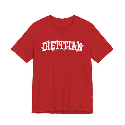 Red tshirt with arched "DIETITIAN" text in white with pink hearts sprinkled throughout the letters