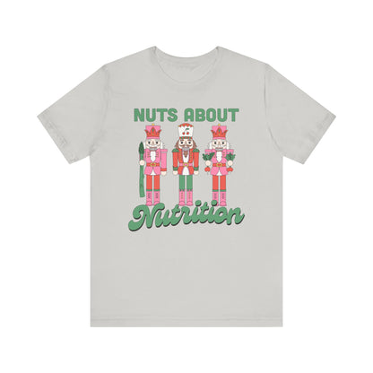 Light gray t-shirt with nutcracker design and 'Nuts About Nutrition' text on a white background