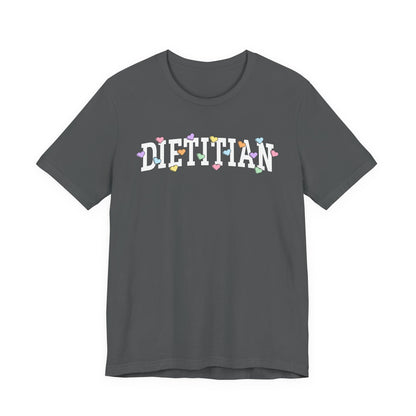 Gray tshirt with arched text "DIETITIAN" with multi-colored Valentine heart candy sprinkled throughout the letters