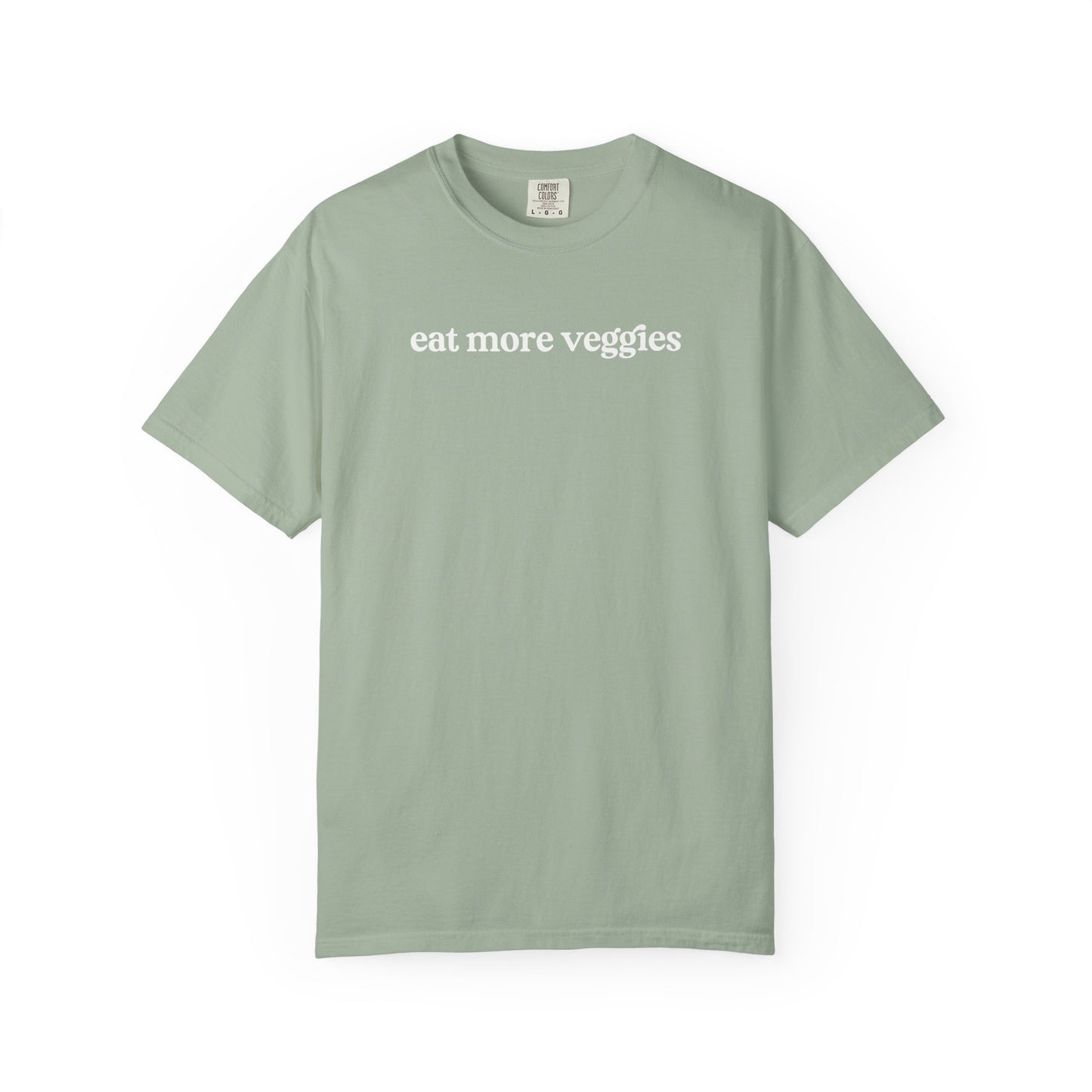 Green t-shirt with 'eat more veggies' text on a white background