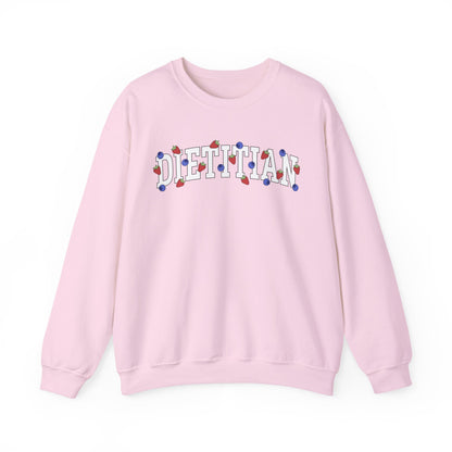 Pink sweatshirt with 'DIETITIAN' text in white with strawberries and blueberries sprinkled throughout letters