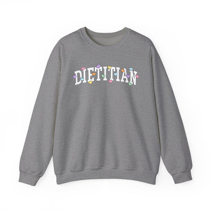Heather gray sweatshirt with arched "DIETITIAN" text in white with multi-colored heart shaped Valentine candy sprinkled throughout the letters.