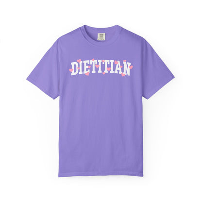 Violet tshirt with arched "DIETITIAN" text in white with pink hearts sprinkled throughout the letters