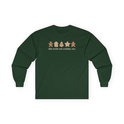 Green long-sleeve shirt with gingerbread-themed design on a white background
