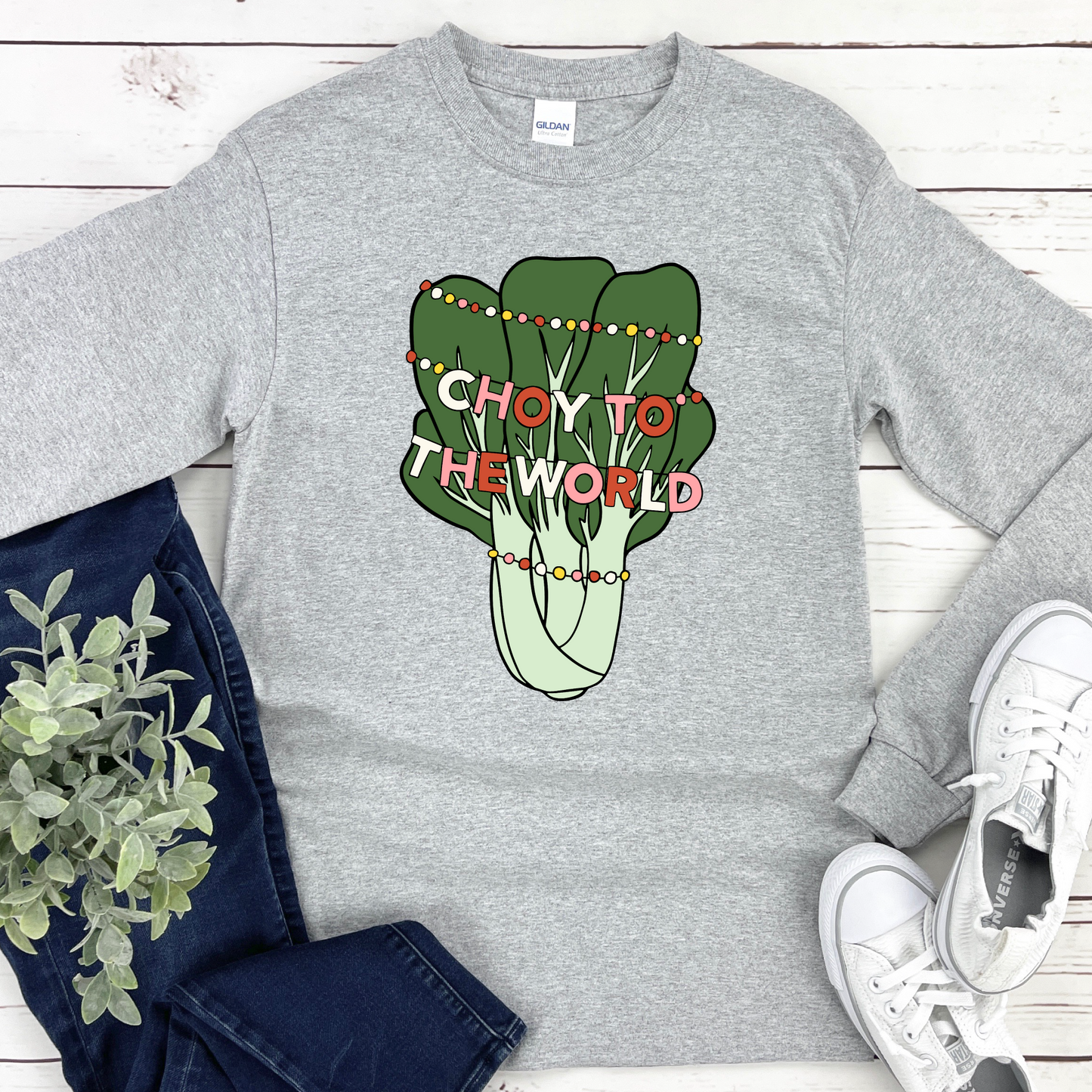 Sport Gray t-shirt with 'Choy to the World' design on a wooden surface with jeans and sneakers.