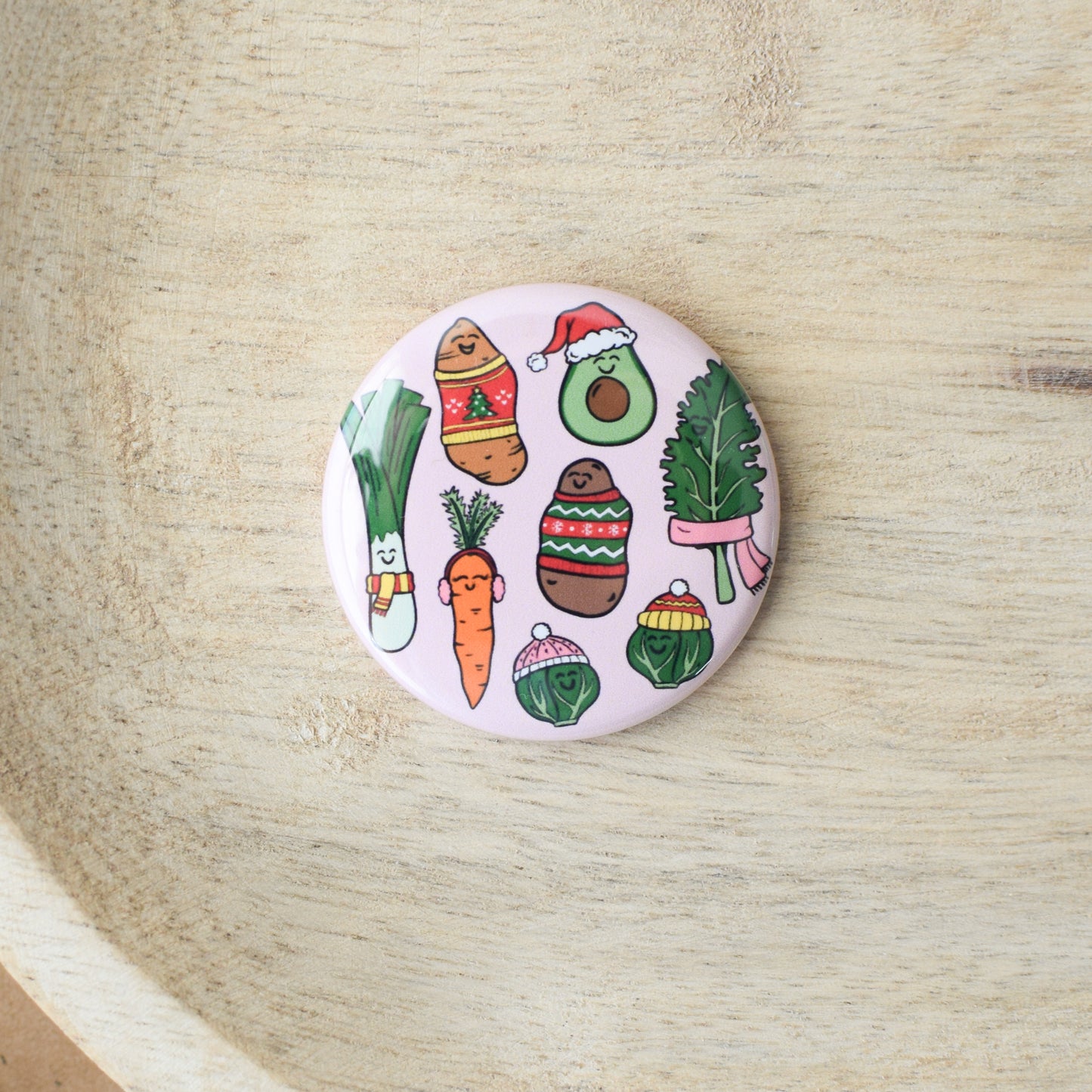 Circular badge with cartoon vegetables on a wooden surface