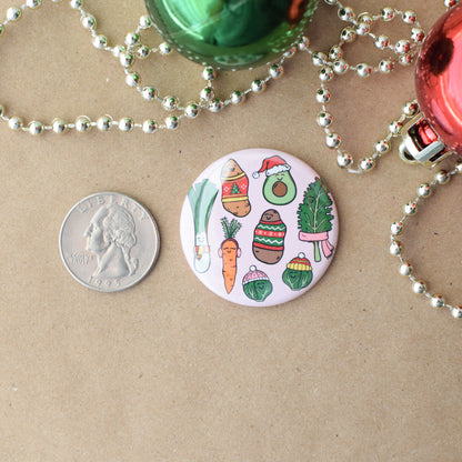 Circular Christmas-themed badge with vegetable illustrations on a brown surface with beads and coins.
