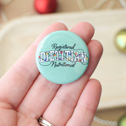 Button badge with 'Registered Dietitian Nutritionist' text held in a hand.