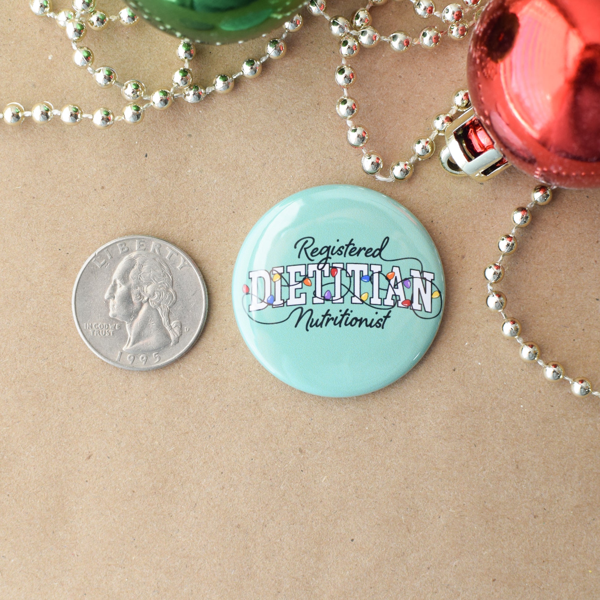 Button badge labeled 'Registered Dietitian Nutritionist' next to a quarter on a brown background