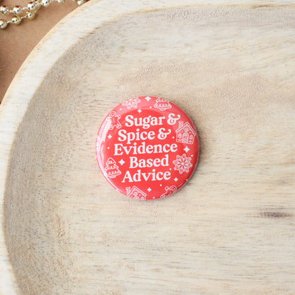 Red button with text 'Sugar & Spice & Evidence Based Advice' on a wooden surface