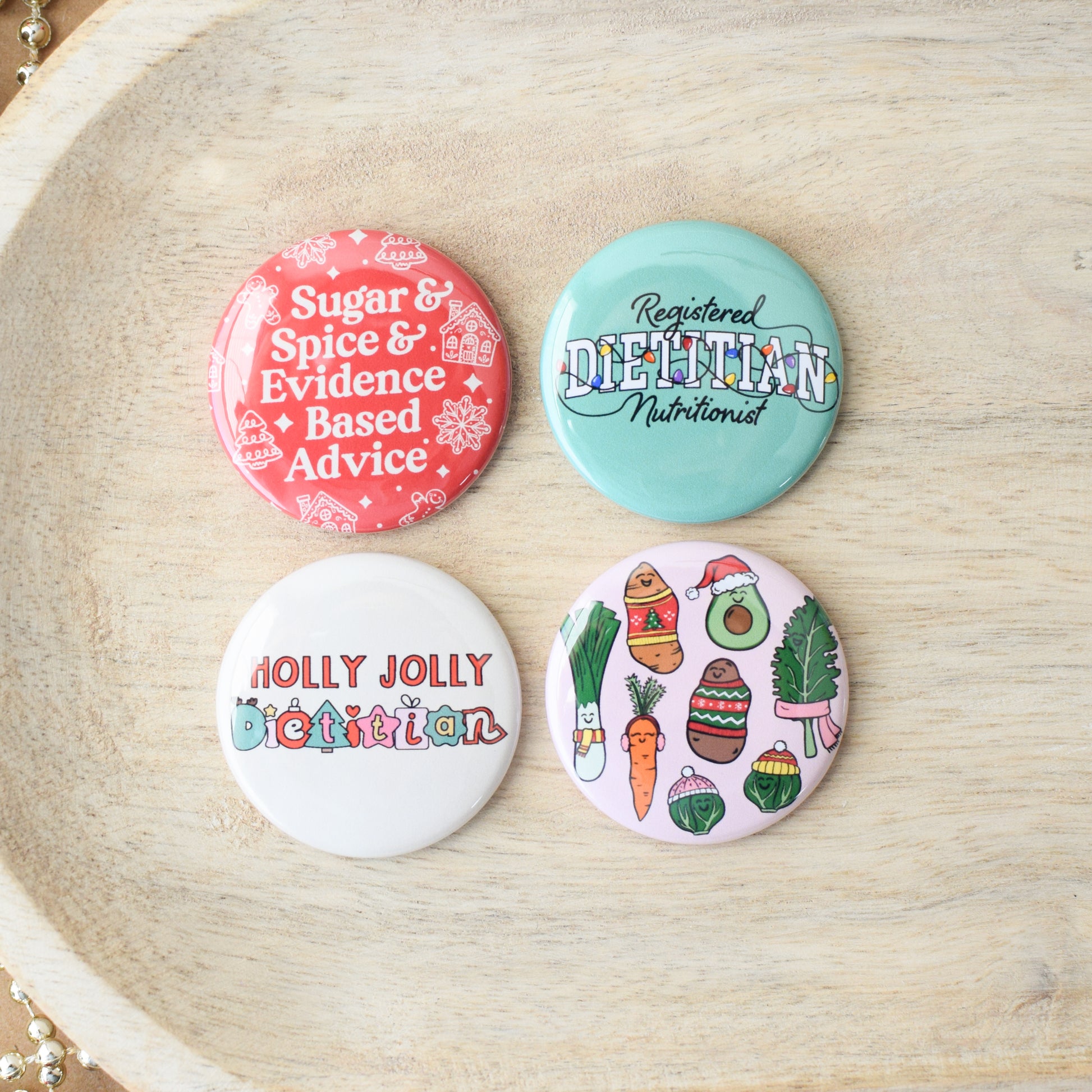 Four buttons with holiday nutrition and dietitian themed designs.