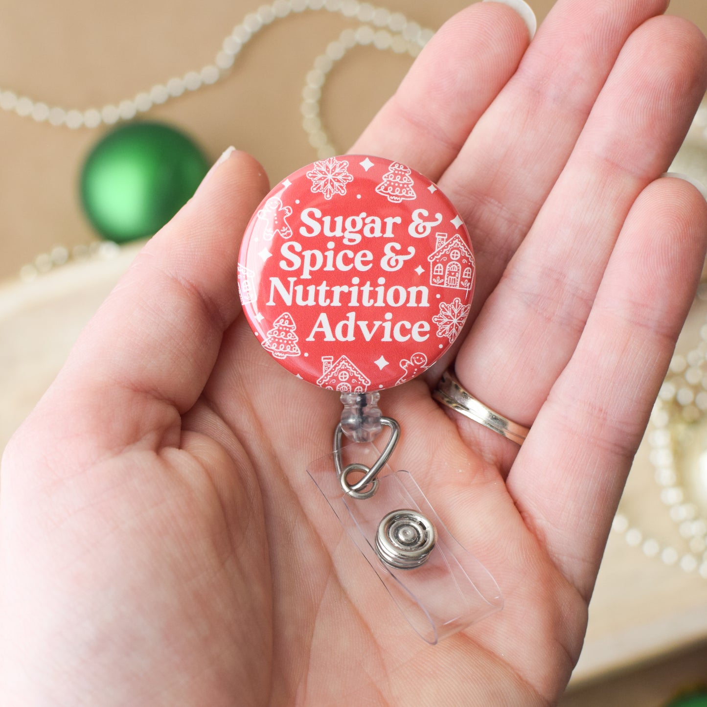 Red badge reel with 'Sugar & Spice & Nutrition Advice' text held in a hand.