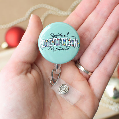 Turquoise badge reel with 'Registered Dietitian Nutritionist' text held in a hand.