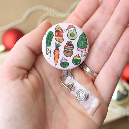 Retractable badge holder with cartoon vegetables design held in a hand.