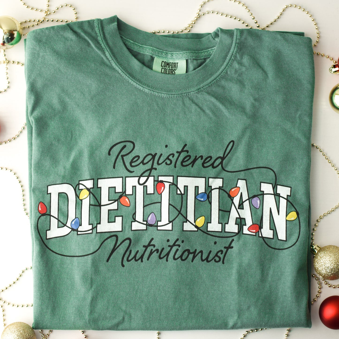 Green tshirt with Registered Dietitian Nutrition text tangled in Christmas lights