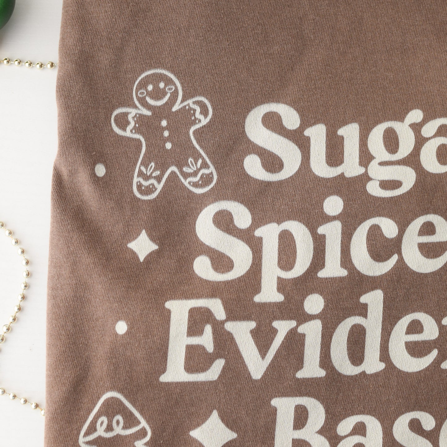 Brown fabric with white text and gingerbread man design on a white background