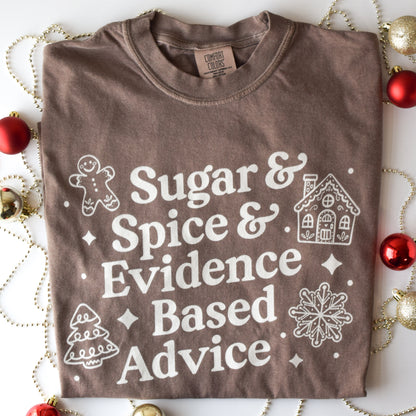 Brown t-shirt with white text and graphics on a decorative background with Christmas ornaments.