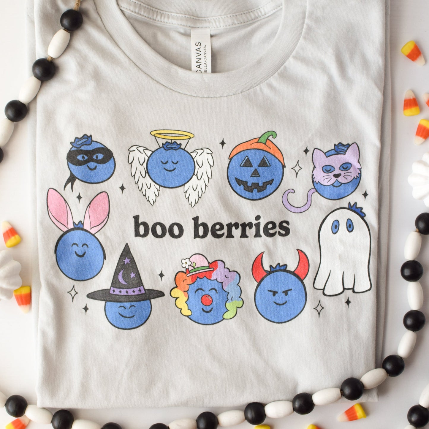 Very light gray tshirt with blueberries in Halloween costumes with the pun "boo berries"