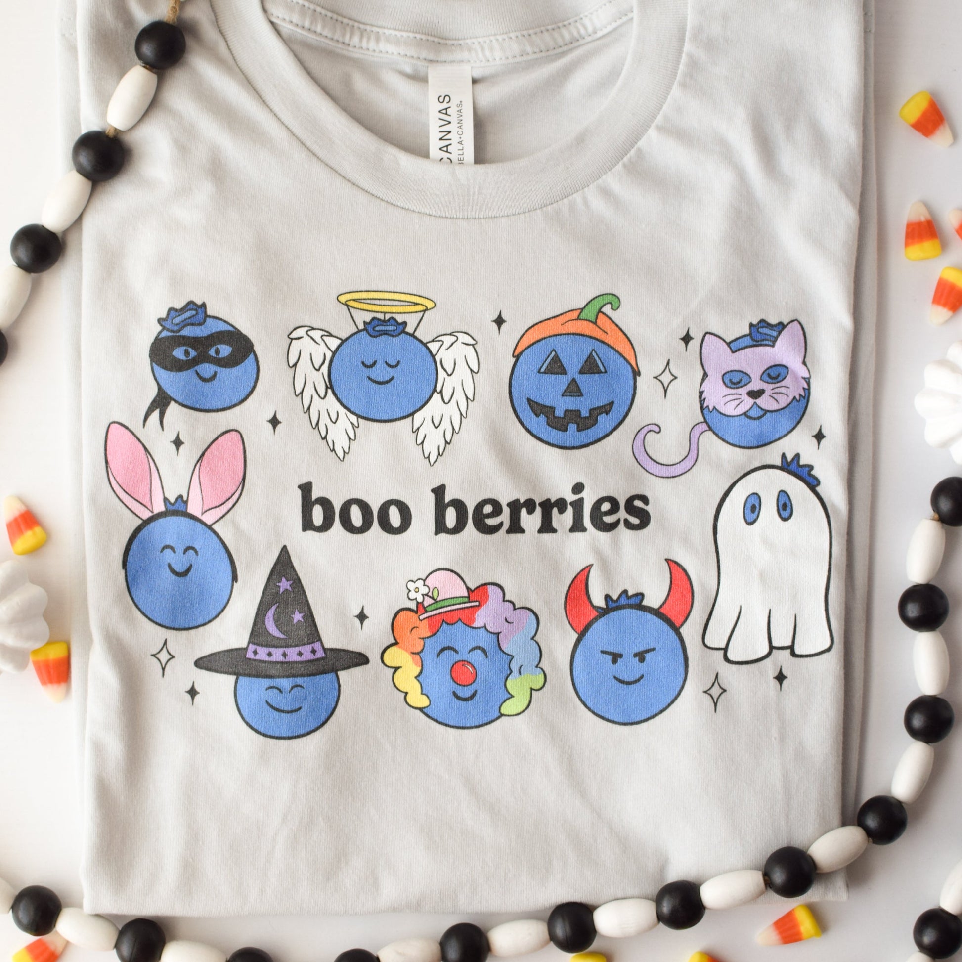 Very light gray tshirt with blueberries in Halloween costumes with the pun "boo berries"