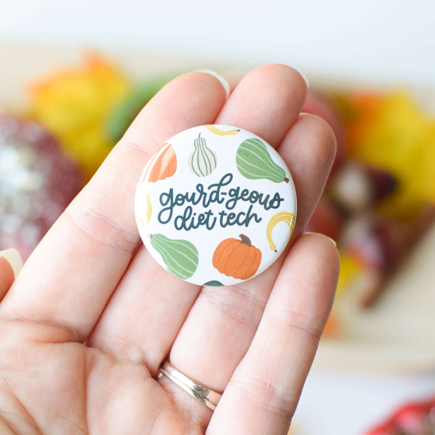 Button badge with 'gourd geous diet tech' text and illustrated gourds held in a hand