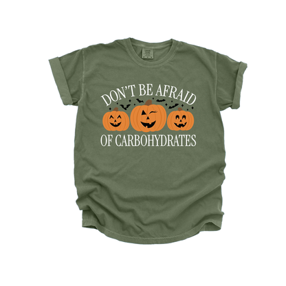 Moss green shirt with "Don't be afraid of carbohydrates" phrase and jack 'o' lanterns