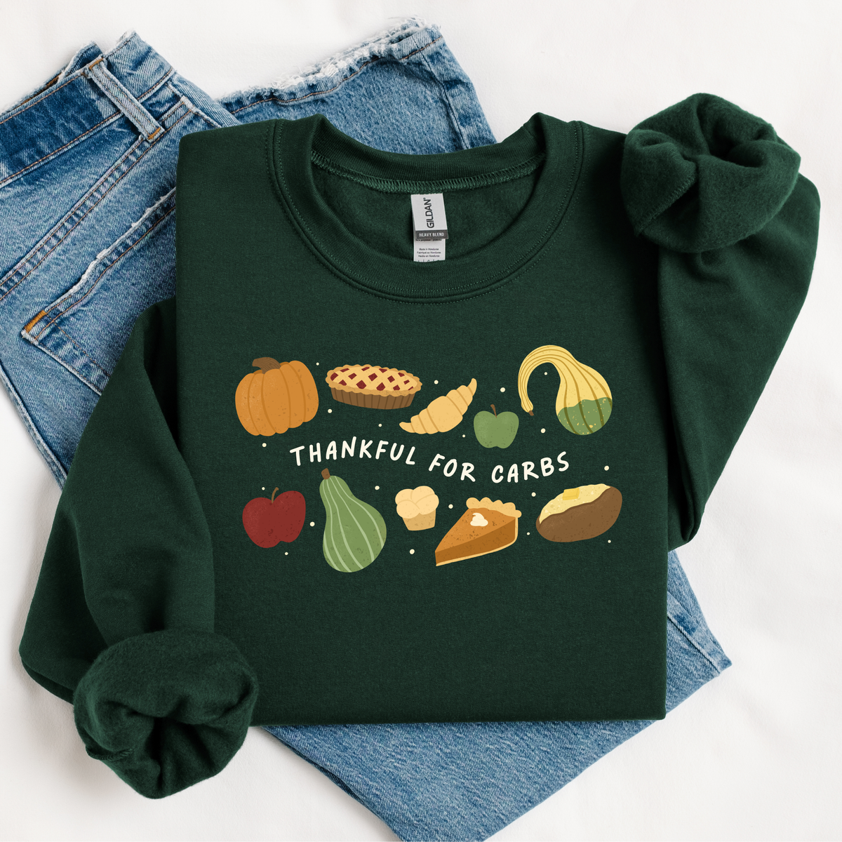Green sweatshirt with autumn-themed graphics and text 'Thankful for Carbs' on a white background